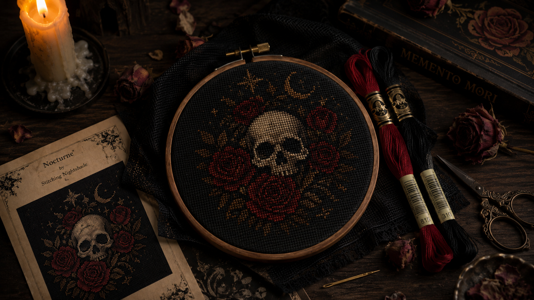 Gothic cross stitch supplies for beginners — black Aida fabric, DMC floss, wooden hoop, and an in-progress dark aesthetic pattern