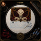 Skull Butterfly Memento Mori cross stitch finished on white Aida fabric with embroidery hoop